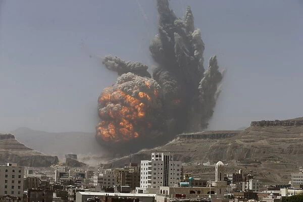 Smoke rises during an air strike on an army weapons depot on a mountain overlooking