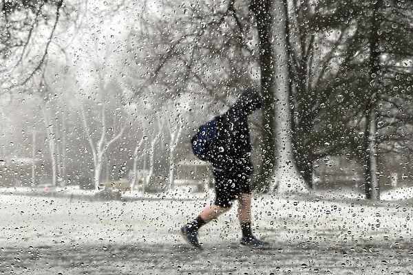 A student walks out of school during the storm in Newtown