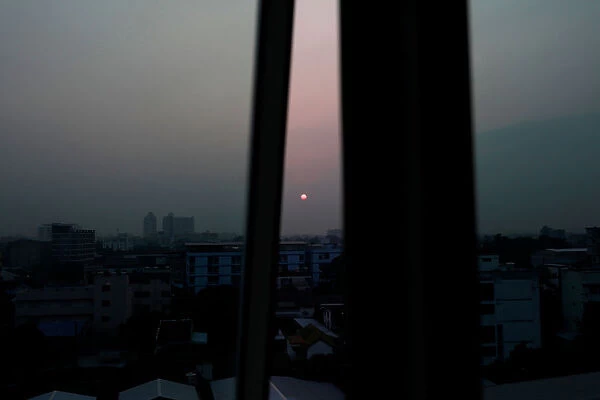 Sun is seen in the skyline in Bangkok