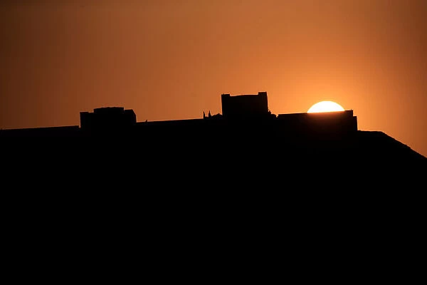 Sunset is seen behind the presidential palace in Damascus