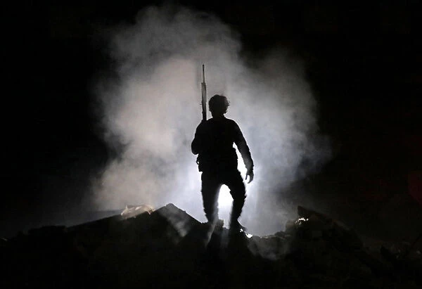 Turkey-backed Free Syrian Army fighter holds a weapon in the town of Tadef in Aleppo