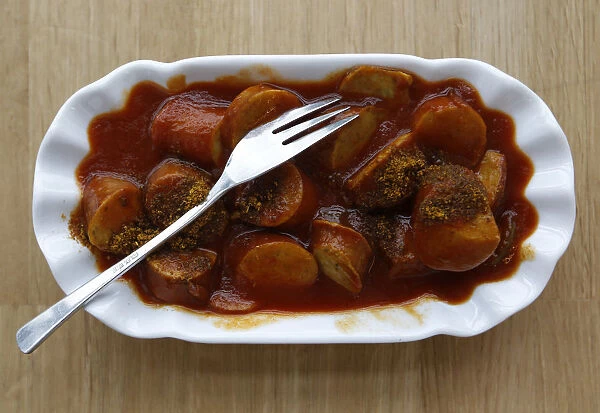 A typical German fast food dish of Currywurst, which is a sausage with curry powder