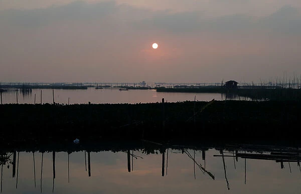 A view of the fish cages during sunrise at Laguna de Bay in Muntinlupa, Metro Manila