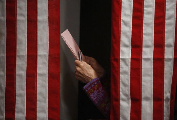 A voter checks her ballot in the Ballot Room of the Balsams Hotel in Dixville Notch