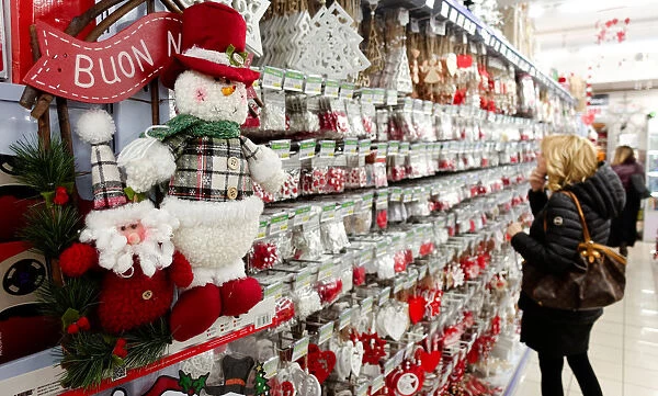 A woman looks at Christmas decorations in a shop in Rome