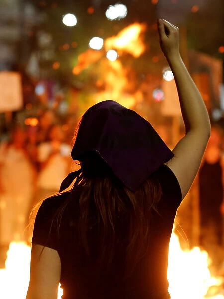 A woman participates in a demonstration as part of International Womens Day in