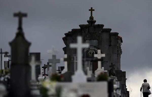 Woman walks along tombs at the municipal cemetery of San Salvador in Oviedo