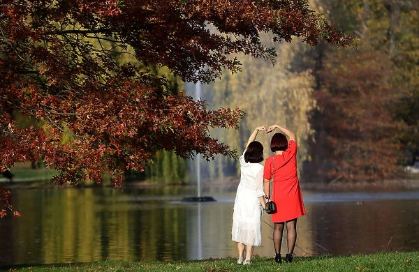Women pose in a park during an autumn day in Prague