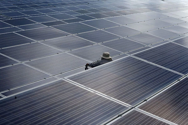 A worker works at a solar power plant by Superblock, Southeast Asias biggest producer of