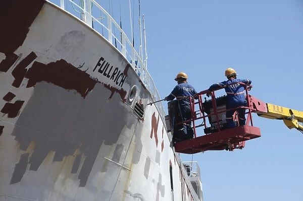 Cargo ship being repainted in dry dock, Cape Town, Western Cape, South Africa