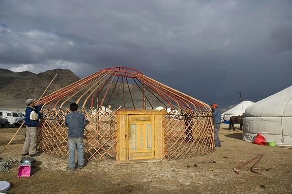 Kazakh nomads erecting ger camp, in preparation for Eagle Hunters Festival, Altai Mountains, Bayan-Ulgii