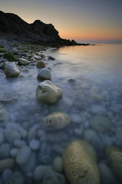 Pebbles on beach at sunrise, Church Ope Cove, Isle of Portland, Dorset, England, july