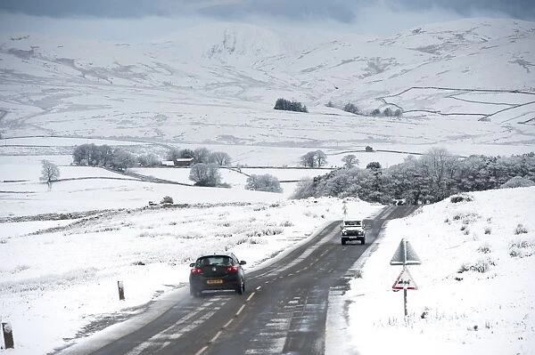 Traffic on road in snowy weather conditions, A683 between Kirkby Stephen and Sedbergh, Cumbria, England, December
