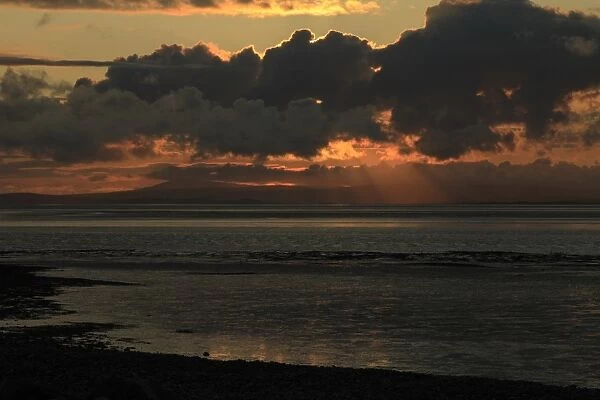 View of intertidal mudflats habitat at sunset, looking towards Grange-over-sands in Cumbria from Morecambe
