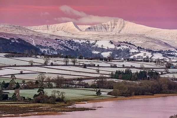 View of snow covered farmland and hills at sunrise, looking from Mynydd Llangorse, Llangorse Lake, Brecon Beacons N. P