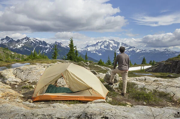 Adult man admiring view from backcountry campsite