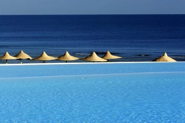 Africa, Egypt, Marsa Alam, Red Sea, beachside pool and umbrellas