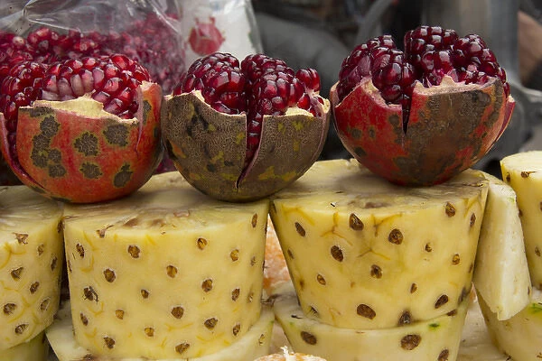 Asia, India, New Delhi, street vendors cart with display of opened pomegranates