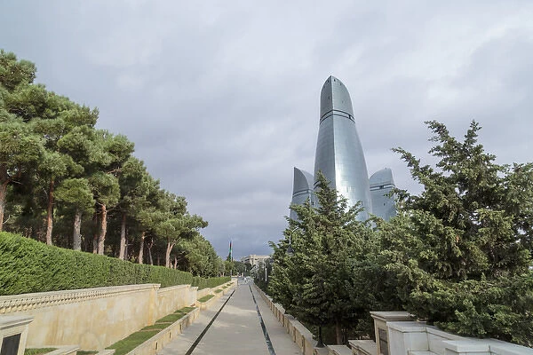 Azerbaijan, Baku. A walkway in Dagustu park, with the Flame Towers in the background