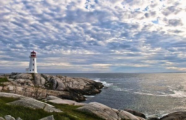Beautiful sky and lighthouse in Peggys Cove in Nova Scotia Canada and rocks