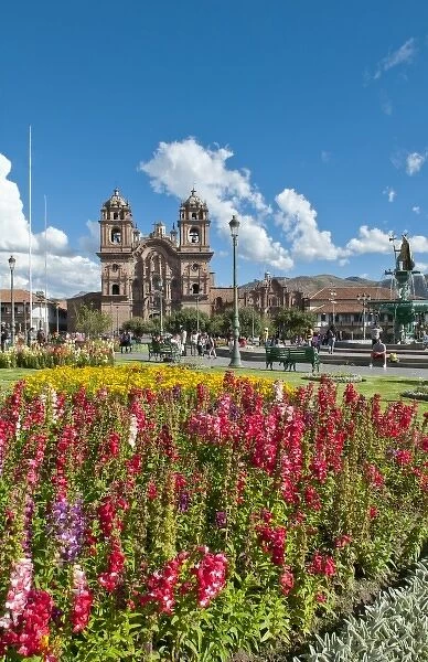 Beautiful visual image of Main Square thru flowers in sunshine of Cusco Cuzco Peru and La Compania