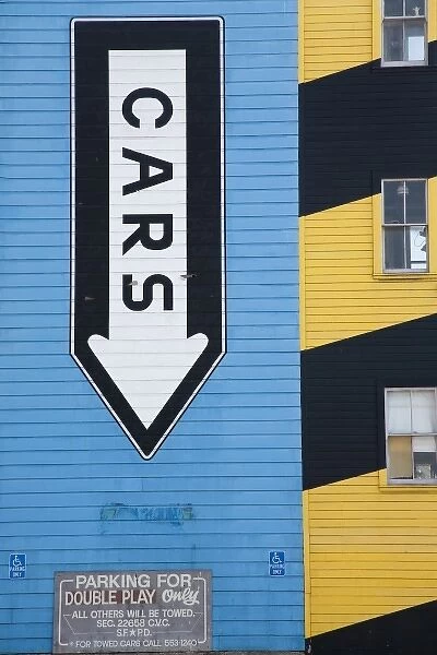 Side of building with graphic sign, cars, San Francisco, California, USA