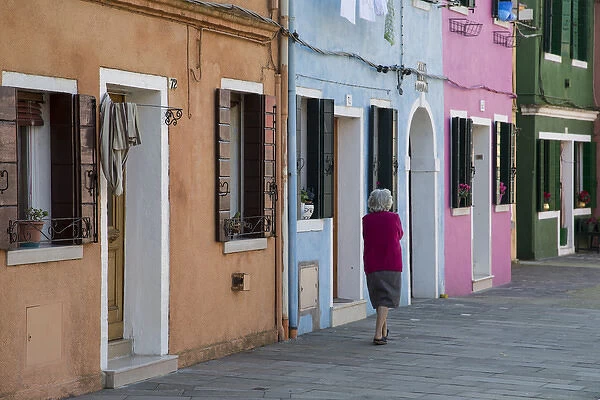 Burano and colorful buildings with elderly lady taking a walk