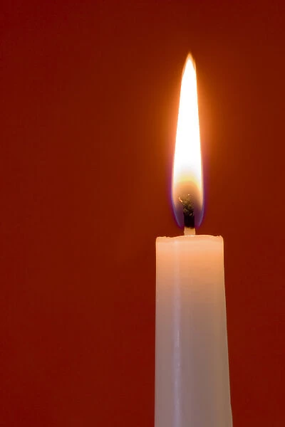 Burning candle on red background. Credit as: Wendy Kaveney  /  Jaynes Gallery  /  DanitaDelimont
