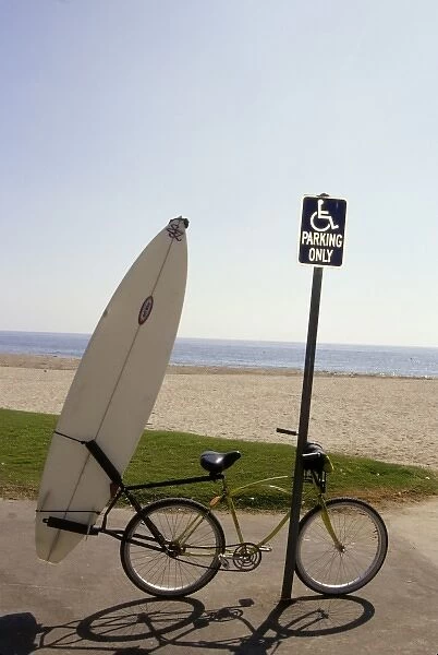 California: Santa Barbara, Leadbetter beach, bike and surfboard resting against sign post