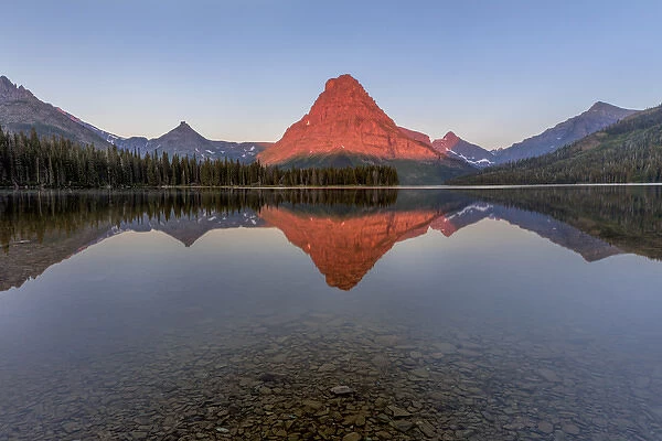 Calm reflection in Two Medicine Lake in Glacier National Park, Montana, USA