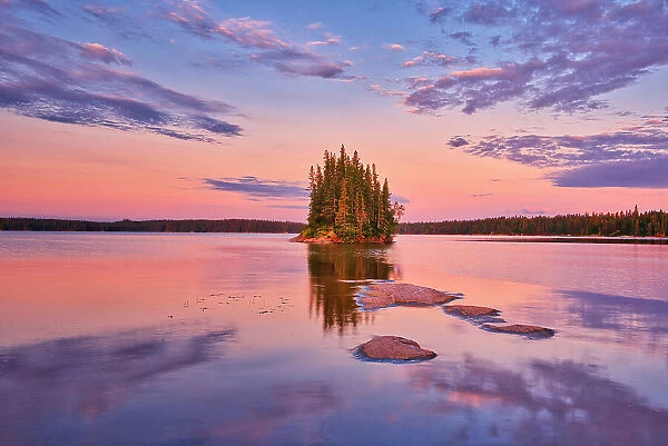 Canada, Manitoba, Paint Lake Provincial Park. Island on Paint Lake at sunrise