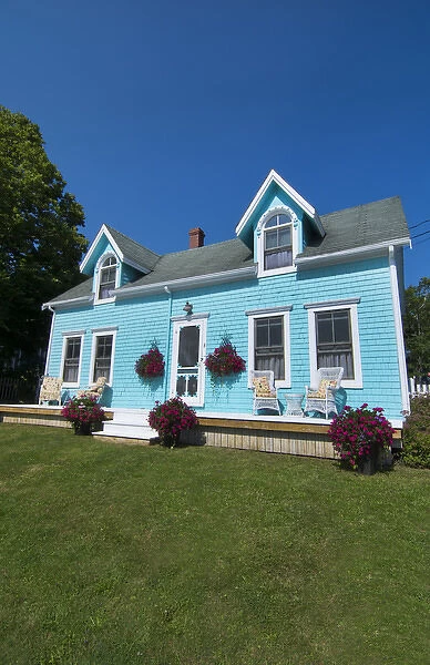 Canada Prince Edward Island, P. E. I. Victoria beautiful blue Victorian home with porch chairs
