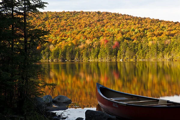 A canoe on the shoreline of Pond of Safety in the Randolph Community Forest