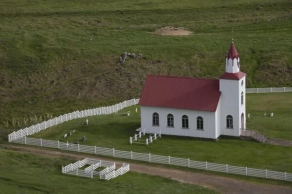 Church and farm in pastoral valley at foot of Mt. Helgafell in southwest Iceland