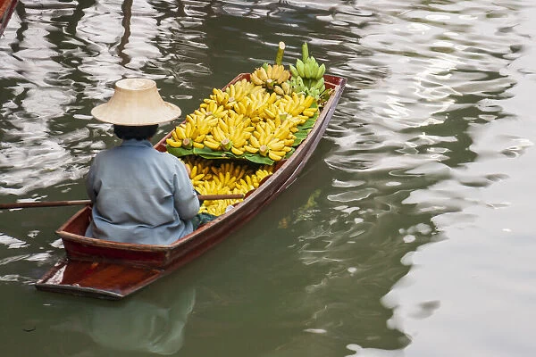 Damnoen Saduak Floating Market, Bangkok, Thailand. Woman with boatload of bananas