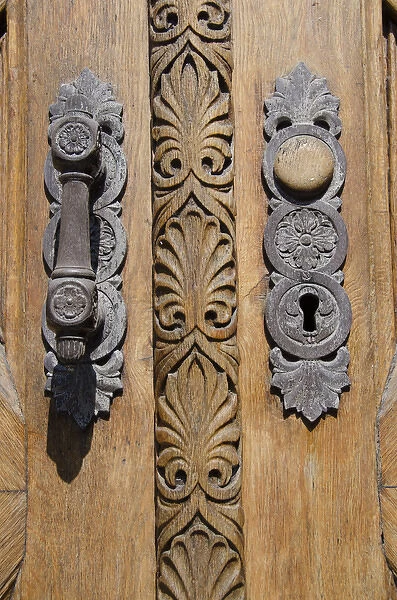 Denmark, Helsingoer. Ornate wooden door of the Helsingoer Kommune Radhus building