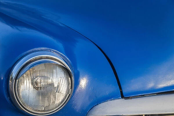 Detail of front end headlight on a classic blue American car in Vieja, old Habana, Havana