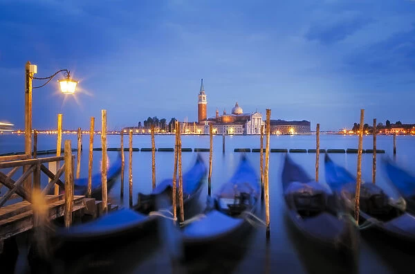 Europe, Italy, Venice. Sunset on gondolas and San Giorgio Maggiore church. Credit as