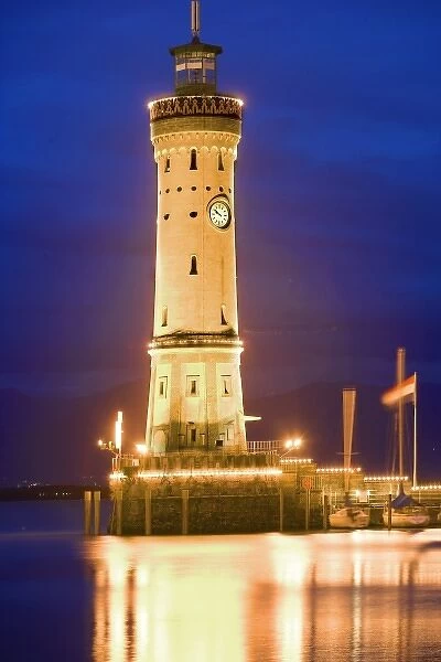 Germany, Lake Constance. View of lighthouse on Lindau Island at sunset