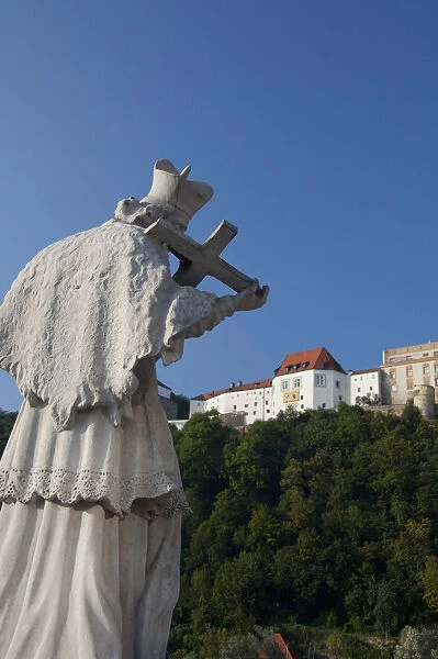 Germany, Passau. Bishop statue in front of hilltop Veste Oberhaus (aka Upper Fortress)