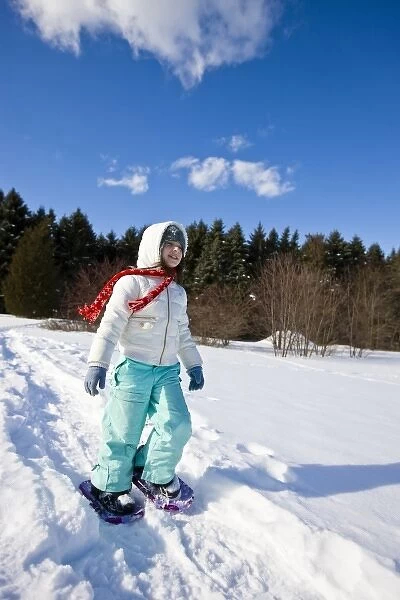 A girl (age 7) snowshoes through a snowy field at the Urban Forestry Center in Portsmouth
