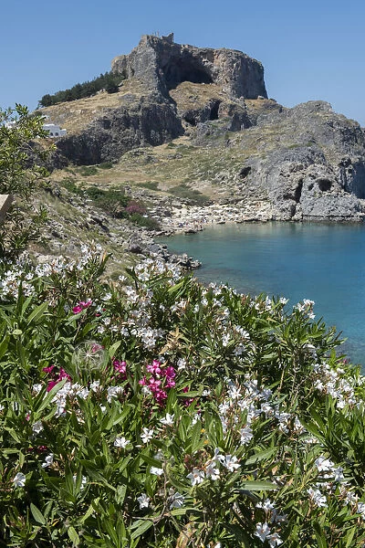 Greece, Rhodes. St. Pauls Bay with the Acropolis of Lindos in the distance with the