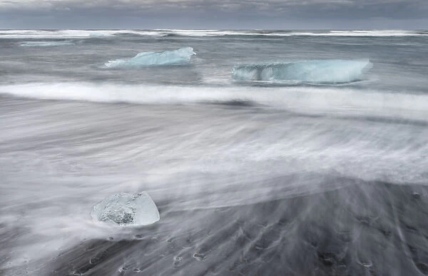 icebergs on black volcanic beach. Beach of the north atlantic near the glacial lagoon Joekulsarlon