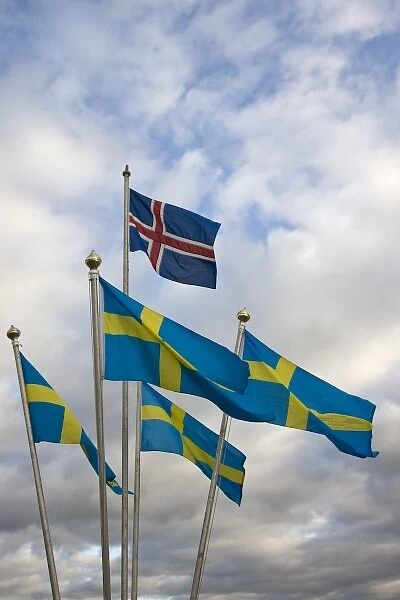 Iceland. The national flag of Norway flies above a grouping of Swedens National flags