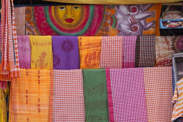 India, Uttar Pradesh, Varanasi. bright pieces of colored cloth for sale along the