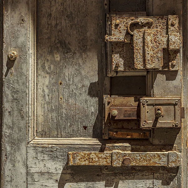 Italy, Apulia, Metropolitan City of Bari, Giovinazzo. Old wooden door with massive rusted