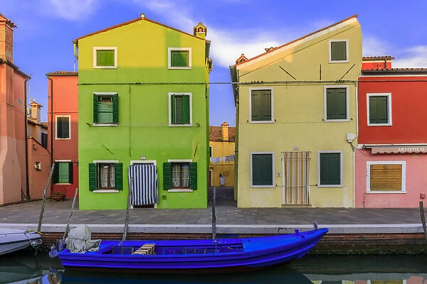 Italy, Burano. Colorful house walls and boat in canal