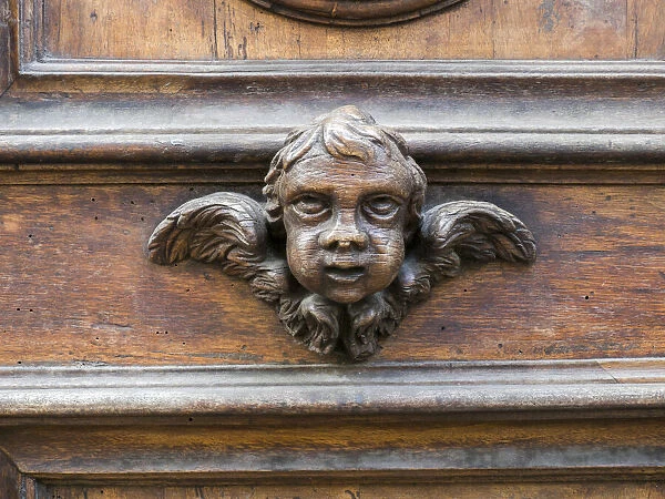 Italy, Florence. Carved ornament on a door in Florence
