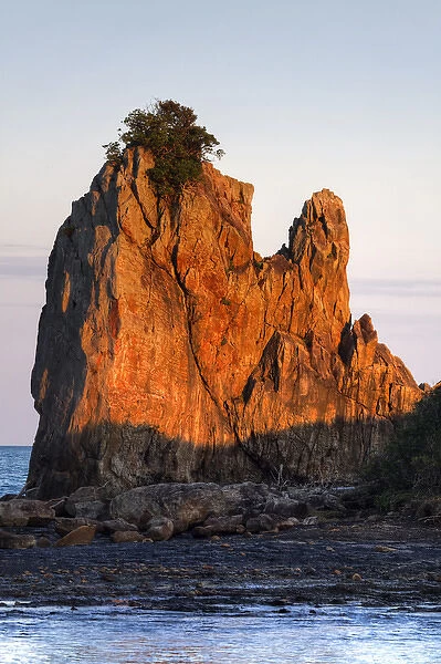 Japan, Wakagama Prefecture. One of the Hashiguiiwa Rocks at sunset