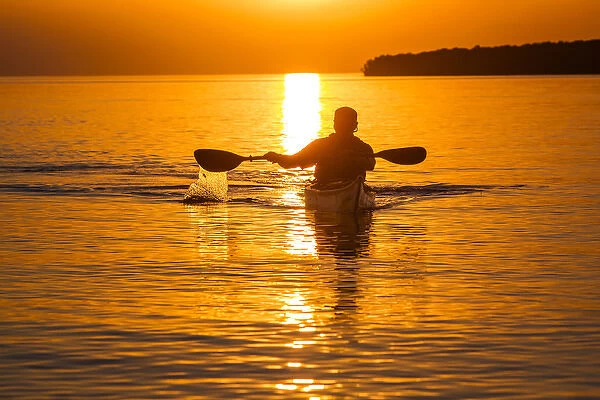 Kayaking at sunset in the Apostle Islands National Lakeshore of Lake Superior near Bayfield